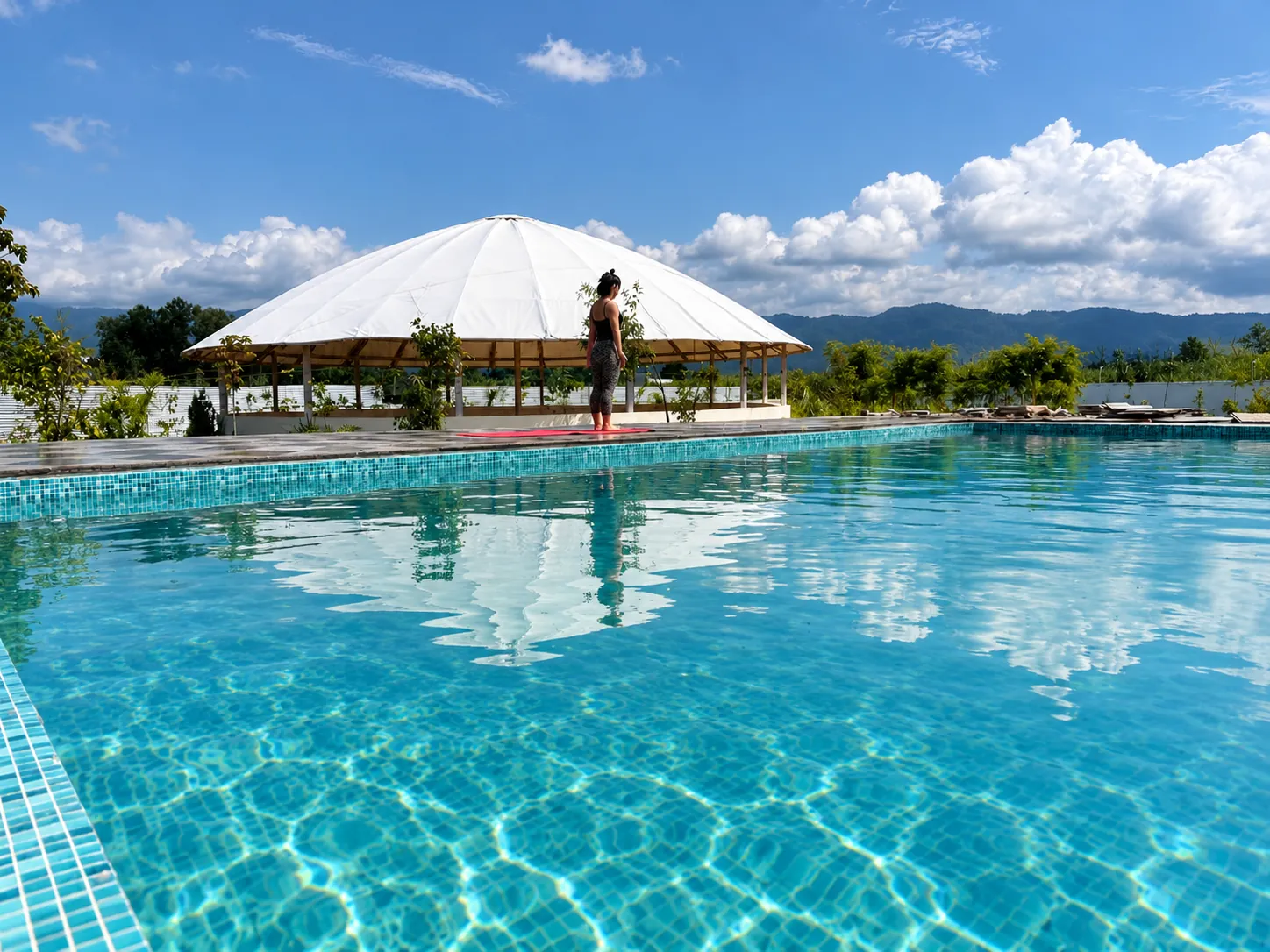Swimming pool and dome yoga hall on the Triguna Yoga School campus